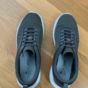 Clarks Cloudsteppers slip on sneakers. Olive green with white soles.